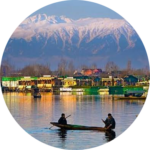Shikara floating on Dal Lake with snow-capped Himalayan peaks in the background.