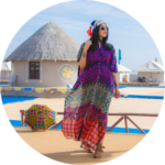 Traveler in colorful traditional attire walking through a cultural village in the Rann of Kutch.